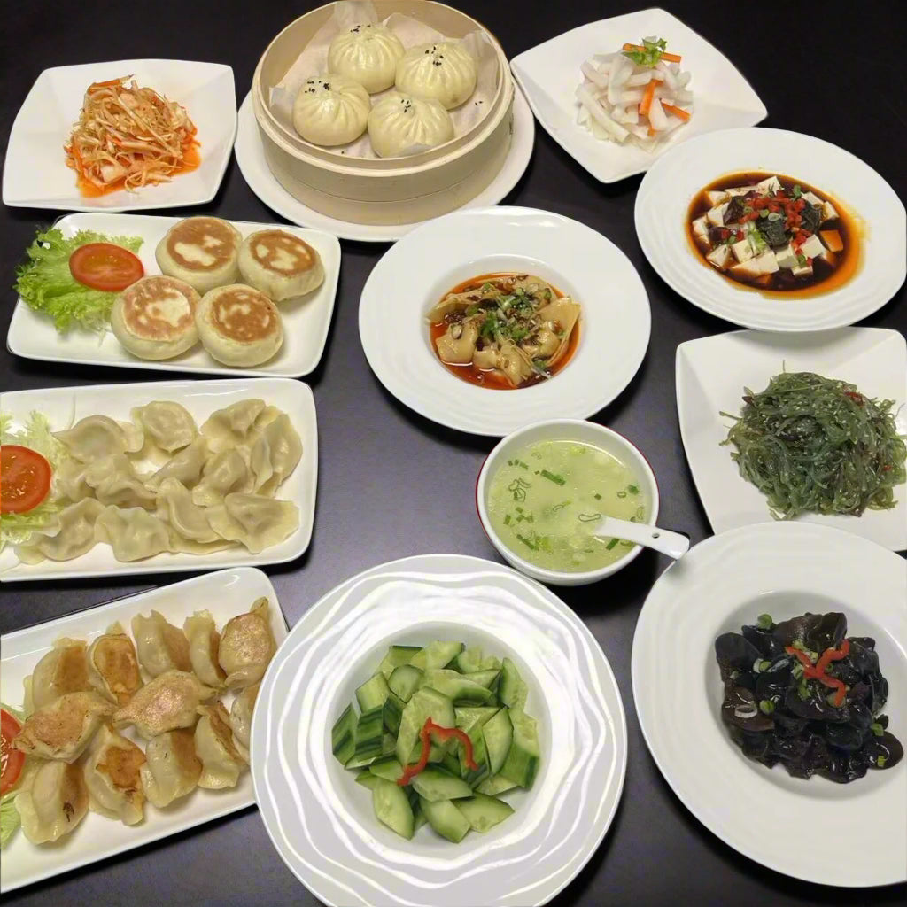 a flat lay of array of chinese dumplings and buns